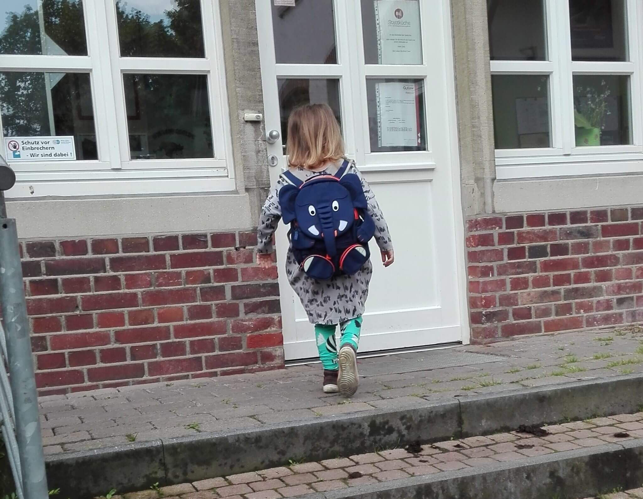 Eingewöhnung - Kind geht mit Rucksack in den Kindergarten