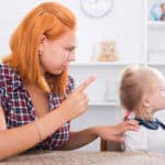 Grenzen setzen - Mutter schimpft mit ausgestrecktem Finger ihre Tochter, die sich wegdreht.